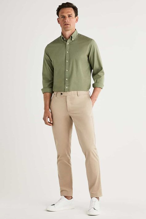 Men's khaki pants, green Oxford shirt and white sneakers outfit. This outfit first appeared in the article: What Colours To Wear With Khaki Pants: 6 Foolproof Shirt Options, on MensFlair.com Green Shirt Khaki Pants Outfit Men, Khaki Formal Outfit For Men, Green Shirt Beige Pants Men, Green Shirt Beige Pants Outfit, White Shirt Green Pants Men, Light Green Polo Shirt Outfit Men, Olive Green Polo Shirt Outfit Men, Beige Khaki Pants Outfit Men, Green White Outfit Men