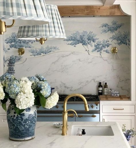 Beautiful French country kitchen with blue accents including range, tree mural behind it, and gingham fabric on shades - via Style Secrets Magazine. #frenchcountrykitchen #bluekitchens French Cottage Backsplash, Blue Floral Kitchen, French Cottage Kitchen Ideas, Cooktop Alcove, Kitchen Wallpaper Blue, Blue French Country Kitchen, French Country Backsplash, Kitchen With Blue Accents, White French Country Kitchen