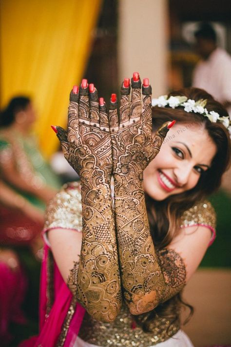 Photo of Bride showing off traditional bridal mehendi Mehendi Photography Bridal, Mehendi Photoshoot, Bridal Mehendi Designs Wedding, Mehendi Photography, शादी की तस्वीरें, Indian Bride Poses, Indian Bride Photography Poses, Indian Wedding Photography Couples, Bridal Photography Poses