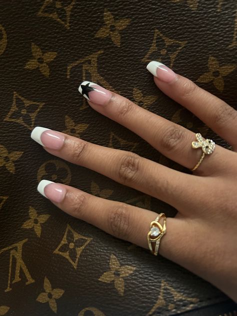 French Nails With Black Stars, White French Tip With Black Star, White French Tip With Stars, White Nails With Black Stars, Black French Tip With Stars, French Nails With Design On Ring Finger, Star French Tips, French Tip With Star On Ring Finger, Black French Tip Star Nails