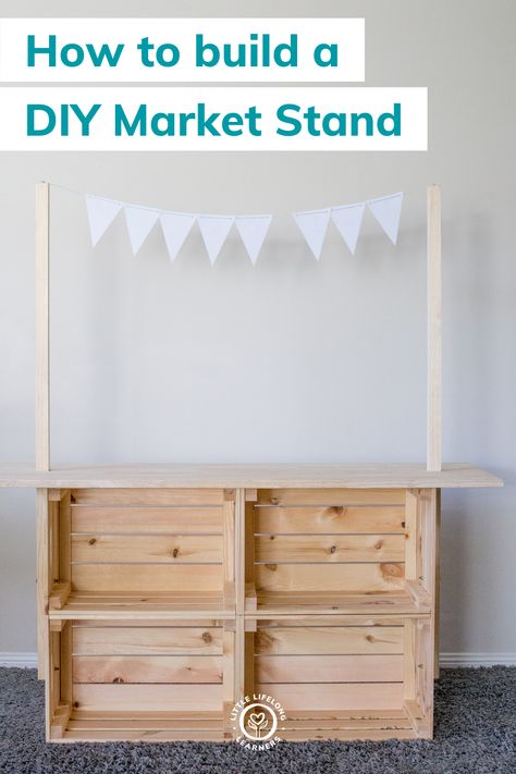 DIY market stand for dramatic play by Little Lifelong Learners. We're sharing how to make a simple DIY market stand for kids using Ikea crates! This DIY Ikea playroom hack is easy, inexpensive, and can be used to transform your play space into a farmers market, grocery store, bakery, donut shop, coffee shop, pizza shop, lemonaide stand, and more. Your kids will love engaging in imaginative play and play-based learning using this DIY market stand! Read the blog post to learn more! Outdoor Play Shop, Shop Play Area For Kids, Play Shop Diy, Ikea Lemonade Stand, Easy Shop Projects, Playroom Market Ideas, Diy Lemonade Stand Kids, Ikea Market Stand Hack, Produce Department Ideas