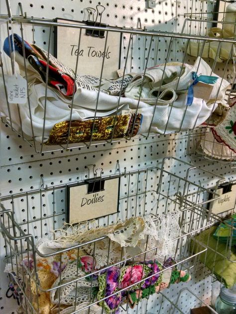 Vintage Freezer baskets and binder clips on pegboard are great display storage for antique or craft booth. Pegboard Shop Display, Antique Booth Pegboard Display Ideas, Decorate A Booth Display Ideas, Antique Shop Display Ideas Craft Booths, Vintage Booth Staging, Antique Fair Booth Display, Pegboard Antique Booth, Pegboard Store Display, Peg Board Antique Booth