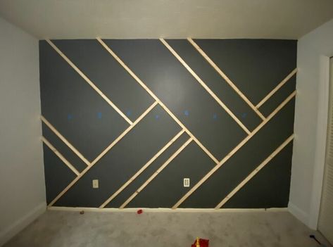 Give your wall some dramatic character with this easy to-do accent wall! Paint the wall I started by painting the wall and the baseboard with the color intended for the whole wall. Mark the studs Using a stud finder, we marked where all the studs in the wall were using blue painter's tape. Cut your wood We used 1"x2" furring strips. We measured the length of the wall where we wanted to place the first piece of wood. I recommend doing your longest lines first. Cut both ends… Dramatic Character, Tape Wall, Stud Finder, Accent Wall Designs, Accent Wall Paint, Bedroom Wall Designs, Accent Walls In Living Room, Bedroom Wall Paint, Accent Wall Bedroom