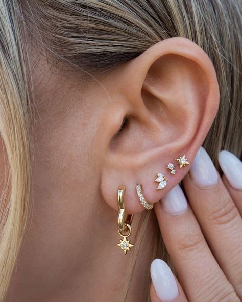 If you're looking for a huggie version of our Johnny earrings, these are it! These tiny hoops fit perfectly around little lobes. Huggie hoop earrings 14k gold plated with sterling base Cubic zirconia accents Protective coating, water resistant Sold as a pair 5 Ear Piercings, 3 Ear Piercings Ideas, 4 Lobe Piercings, Lobe Piercing Ideas, Ušný Piercing, 3 Ear Piercings, Multiple Piercings Earrings, Ear Stacks, Minimalist Ear Piercings