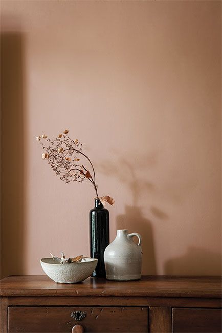 A vase, jug and bowl on a wooden dresser against a wall in a soft, pink-tinged brown paint color. - Benjamin Moore's Metallic Gold 2163-40. Via @benjamin_moore 2023 Interior Design, Brown Paint Colors, Pink Paint Colors, Purple Rooms, Wooden Dresser, Warm Home, Benjamin Moore Colors, Paint Color Palettes, Brown Paint