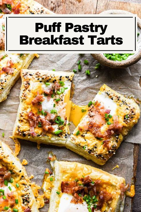 These Puff Pastry Breakfast Egg Tarts are a fun and unique way to enjoy a classic egg and bacon breakfast. You have flaky puff pastry with a jammy egg baked right in the center, topped with cheese, crispy bacon, and chives. You can even crust your puff pastry with everything but the bagel seasoning. Perfect for any weekend breakfast or fun Sunday brunch. Brunch Pigs In A Blanket, Ham And Cheese Breakfast Pastry, Puff Pastry And Bacon Recipes, Puff Pastry And Egg Recipes, Egg Pastry Puff, Puff Pastry Brunch Ideas, Quick Breakfast Pastry, Fun Sunday Breakfast Ideas, Scrambled Egg Puff Pastry