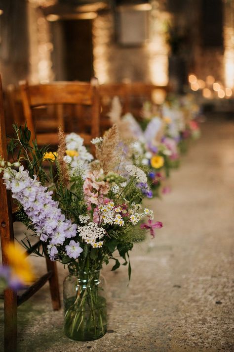 Pretty and colourful flowers in glass vases as aisle wedding decor made up of purple, pink, yellow and white wildflowers Wedding Aisle Decor, Wedding Isles, Aisle Flowers, Wedding Aisle Decorations, Spring Wedding Flowers, בר מצווה, Rock My Wedding, Aisle Decor, Wildflower Wedding