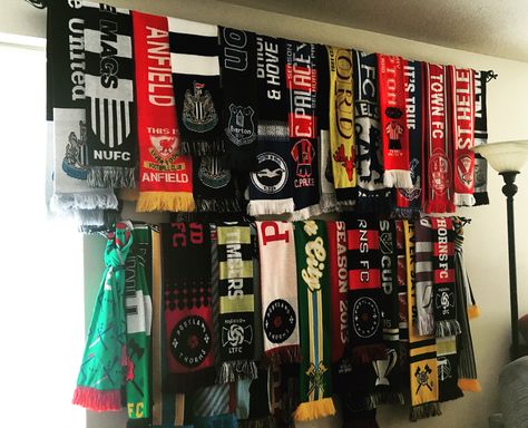 Soccer scarf display using curtain rods from Walmart. Soccer Scarf Display, Scarf Racks, Scarves Display, Costume Room, Scarf Wall, Scarves Store, Soccer Room, Soccer Flags, Soccer Scarf