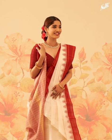 Presenting 𝐍𝐚𝐮𝐫𝐚𝐭���𝐚𝐧
Colourful Silk Sarees Designed for Joyful Festivities💫

The auspicious white colour represents peace and spirituality, this Kanchipuram Cotton saree is elevated with a scintillating silk temple border. 💫 Bangali Saree Style Saris, Saree White And Red, Bangla Culture, Saree Styling Ideas, Red And White Saree, Saree White, Draping Styles, Saree Styling, Saree Drape