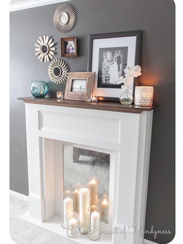 In lieu of a fire, set up a display of candles for an elegant flame. #fireplaces #decor Fake Fireplace, Faux Fireplace Diy, The Mantle, White Fireplace, Faux Fireplace, Mantel Decor, The Fireplace, Fireplace Mantle, Mantle Decor