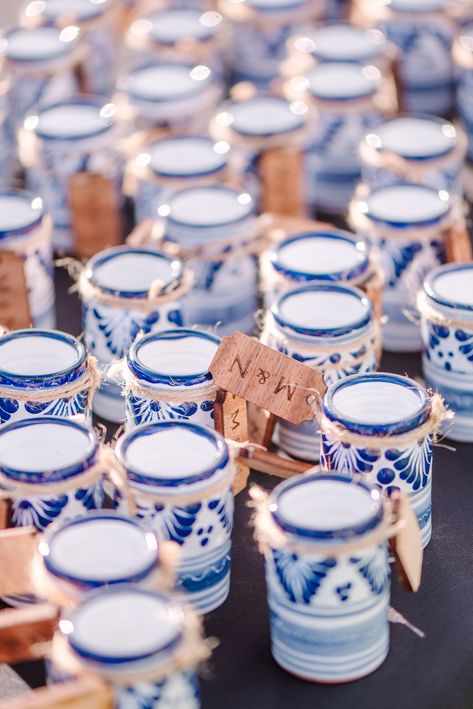 Blue and white talavera shot glasses pictured with the bride and groom's initials tagged. Wedding Favors For Guests Mexican, Mexico Wedding Party Favors, Blue Hacienda Wedding, Wedding Favors Mexican, Wedding Favors Aesthetic, Mexican Favors Ideas, Mexican Wedding Party Favors, Blue And White Talavera Wedding, Colombian Wedding Ideas