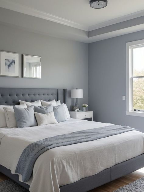 Create a soothing atmosphere with a blue-gray accent wall in your bedroom. Complement it with crisp white bedding, a mirror with a wooden frame, and a soft gray area rug for a modern and elegant look. Gray Accent Wall Bedroom, Gray Accent Wall, Bedroom Wall Colour Combination, Soothing Bedroom Colors, Modern Bedroom Colors, Comfortable Bedroom Decor, Beautiful Bedroom Colors, Blue Bedroom Walls, Best Bedroom Colors