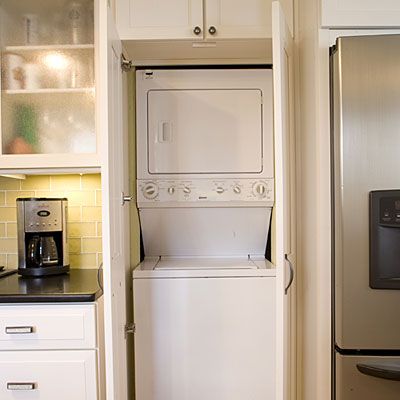 stacked washer and dryer in laundry closet in kitchen, Southern Living Apartment Laundry Closet, Apartment Laundry Room Decor, Laundry In Kitchen, Apartment Laundry Room, Laundry Room Stackable, Laundry Closet Organization, Apartment Laundry, Compact Washer And Dryer, Laundry Room Storage Shelves