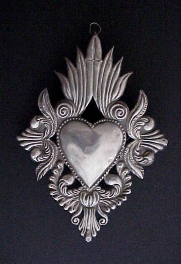 Vintage Sacred Heart Milagro, Ex Voto | This is a beautiful old South American sterling silver milagro, or ex voto from the early part of the 20th century. | The ex voto was left in a church in Peru by a pilgram or devotee giving thanks for his or her wish fulfilled. This large milagro, formed from one sheet of silver, is in the shape of the sacred heart and decorated with traditional Spanish colonial foliate designs in deep repoussé. Tattoo Heart, Metal Embossing, I Love Heart, Tin Art, My Funny Valentine, Mexican Art, Mexican Folk Art, Heart Art, Heart Tattoo