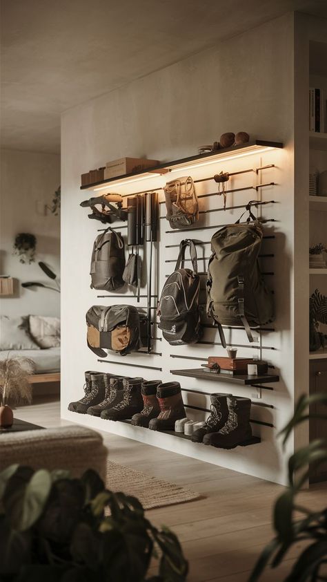 A minimalist room with a sleek camping gear wall, organizing outdoor adventure gear in a clean, simple way. Hiking Gear Wall, Winter Gear Organization Entryway, Man Cave Organization Ideas, Saddle Storage Ideas, Hunting Gear Organization, Gear Room Ideas, Hunting Gear Storage, Outdoor Gear Organization, Sports Gear Storage