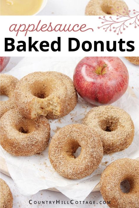 Delight your family and kids with baked applesauce donuts coated in crunchy cinnamon sugar! The easy apple donut recipe is a delicious fall treat and great for Thanksgiving brunch. Make a batch of these apple cinnamon donuts with just 7 ingredients in 30 minutes or less. They are soft and moist, super fluffy and perfectly spiced and easier than fried doughnuts. Serve these applesauce cake donuts for parties, potlucks, and whenever you need a cozy and comforting treat. | CountryHillCottage.com Applesauce Cake Donuts Baked, Apple Baked Donut Recipes, Applesauce Donut Recipe, Baked Applesauce Donut Recipes, Baked Apple Donuts With Donut Pan, Healthy Homemade Donuts Recipe, Apple Sauce Donuts Recipe, Applesauce Donuts Baked, Apple Doughnuts Baked