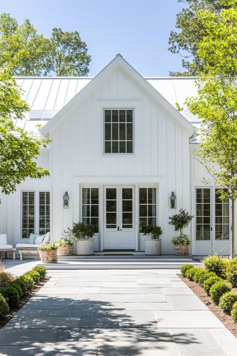 Cozy Coastal Farmhouse Exterior, White Board and Batten Siding, Metal Roof Design, Farmhouse Curb Appeal, Modern Farmhouse Style, Front Porch Inspiration, Symmetrical Home Design, Rustic Outdoor Decor, Light and Airy Exterior, Coastal Cottage Home, Elegant Farmhouse Entrance, Slate Walkway, Natural Landscaping Ideas, White Farmhouse Exterior, Classic Home Architecture Metal Roof Board And Batten Siding, Modern Farmhouse With Detached Garage, Exterior Addition Ideas, White Farmhouse White Windows, White Metal Roof House, White House With Metal Roof, White Cabin Exterior, White Roof House, Metal Roof Design