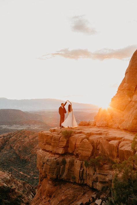 Couple in wedding dress and suit, dancing and twirling on the edge of a red rock cliff at sunset in sedona arizona. Rock Wedding Ideas, Sedona Wedding Colors, Sedona Family Photos, Arizona Wedding Ideas, Az Elopement, Desert Elopement Arizona, Red Rocks Elopement, Sedona Wedding Photos, Sedona Arizona Wedding