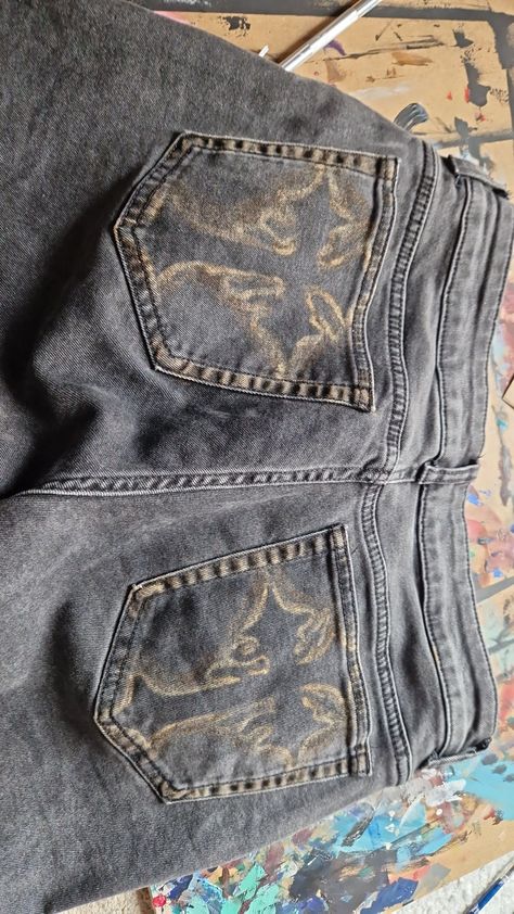 Bleached jeans crosses DIY alternative Skeleton Pants Bleach, Bleach On Black Jeans, Painting Jean Pockets, Bleaching Jeans Ideas, Grunge Jeans Diy, Upcycle Clothes Aesthetic, Bleach Art On Jeans, Alt Jeans Diy, Jeans With Patches Diy