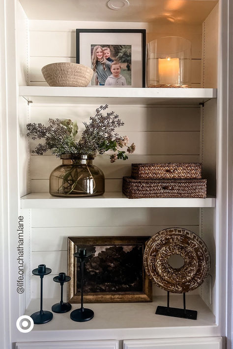 Spruce up your space with a modern-rustic vibe you’ll love for seasons to come. Mix & match textured decor accents. Add a glass vase with faux flowers to make your space extra cozy. P.S. Add these to your entryway, bookshelf or your dresser to liven up any corner. Fall Shelf Decor Ideas, Built In Shelf Decor, Cabinet Styling, Apartment Finds, Shelf Decor Living Room, Styling Shelves, Room Vibes, Bookcase Decor, Bookshelf Styling