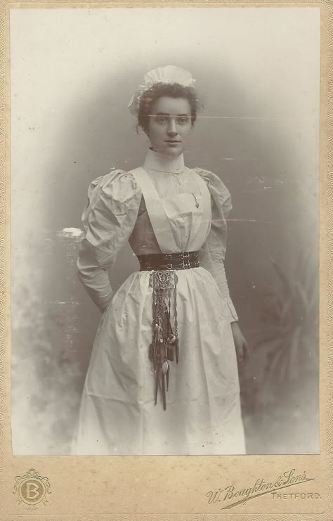 https://flic.kr/p/SxF6rR | Unidentified Nurse,Thetford Cabinet Card | the  Chatelaine attached to her belt looks to be so heavy that she needs a reinforced belt! Chatelaine Belt, Victorian Doctor, Victorian Maid, Doctor Outfit, Nurse Aesthetic, Vintage Nurse, Dress History, Uniform Dress, 19th Century Fashion