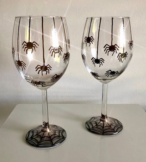 Happy Spooky Season!! This creepy crawly wine glass includes Hand Painted spiders! There are 8 spiders on webs and a few more below them on these MADE TO ORDER glasses. The spiders cover one half of the glass. Each spider has been detailed with 8 little legs and a set of two eyes (there should be 6.. but that's okay!). These spiders are descending from the top of the glass and on their way back to their spiderweb below! Depending on which glass style you choose, you will see a spiderweb on the bottom of your glass. These glasses are the perfect gift for any lover of spooky things, spiders, or Halloween fun!  I also offer several other Fall/Halloween designs. Please contact me if you would like to mix and match a SET of Glasses with others in my shop. I would be happy to create a "private l Halloween Diy Wine Glasses, Halloween Painted Shot Glasses, Halloween Cup Painting Ideas, Glass Halloween Decor, Halloween Glass Painting Ideas, Spooky Wine Glasses, Halloween Shot Glasses Diy, Halloween Wine Glasses Diy Painted, Wine Glass Painting Ideas Halloween