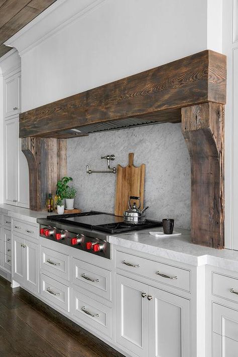 A custom white range hood is accented with reclaimed wood planks. Farmhouse Range, White Kitchen Hood, Decoration Ideas Kitchen, Kitchen Cabinets Design, Kitchen Decoration Ideas, Kitchen Hood Design, Home Decor Ideas Bedroom, Kitchen Vent Hood, Wooden Kitchen Cabinets