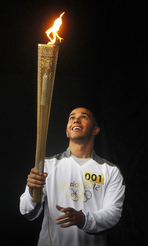 Formula One driver Lewis Hamilton poses for a photograph with the Olympic Flame before his London 2012 Olympic Games torch relay through Luton, in southern England Olympic Flame, F1 Lewis Hamilton, Southern England, 2012 Olympics, Olympic Torch, Paris Summer, Sports Photos, Summer Olympics, New Poster