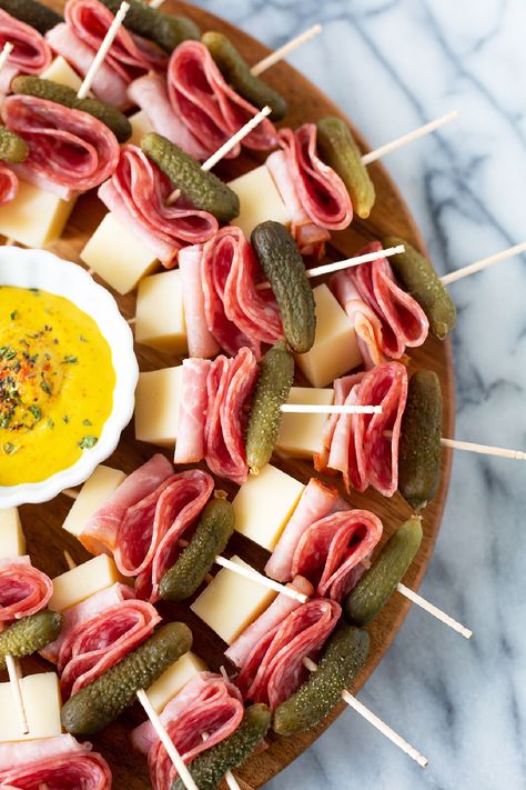 These delish Cuban sandwich skewers are undoubtedly the easiest appetizer ever! All you need to do is layer salami, ham, Swiss cheese, and a mini pickled dill on a skewer, to have yourself a low-carb little Cuban sandwich on a stick. Don't forget to add some dijon mustard for dipping! Club Sandwich Skewers, Best Finger Sandwich Recipes, Pickle Rollups Appetizers, Ham Decoration Ideas, Cheese And Salami Skewers, Meat And Cheese Toothpick Appetizers, Cold Finger Sandwiches For A Crowd, Easy Baby Shower Appetizers, Salami Cheese Skewers