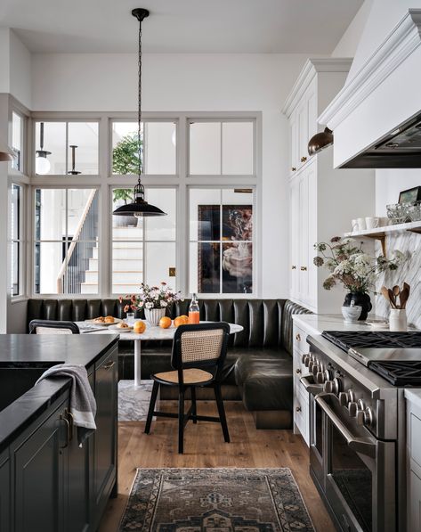 Interior windows allow light into the dining nook, where a leather banquette upholstered by HM Duke Design wraps around a Calacatta marble table. The chairs are from Jayson Home and the pendant is from Obsolete. Katie Leclercq, Leather Banquette, Black And White Kitchen, Lake Washington, Mercer Island, Interior Windows, Kitchen Nook, Luxe Interiors, Studio Interior