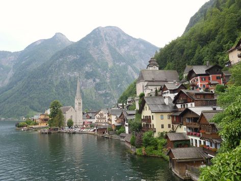 Lovely little town on a cliff next to a lake. It is called #Hallstadt . #city #town #greatview #mountain #buildings #alps #lake #landscape #outdoors #foggy #oldbuildings Small Farming, Mountain Aesthetic, Mountain City, Location Inspiration, City Pictures, Lake Pictures, Mountain Village, Lake Landscape, Mountain Town