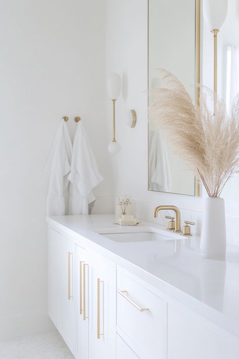 Discover modern bathroom ideas that elevate your space with elegance and simplicity. This design features clean lines, minimalist fixtures, and a soothing color palette. Perfect for a fresh and stylish update! #ModernBathroom #HomeDesign #InteriorDecor Simple Chic Bathroom, White And Gold Half Bath, White Mid Century Bathroom, Sisters Bathroom Ideas, Modern Simple Bathroom Design, White Gold Bathroom Ideas, White Bathrooms Modern, White Clean Bathroom, White And Bronze Bathroom