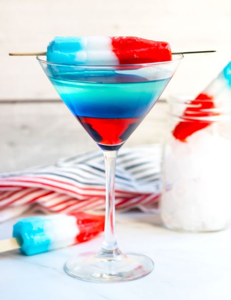 This Bomb Pop Martini has layers of red, white and blue that make a perfect martini for the 4th of  July or Memorial Day.  The fun, patriotic appearance is achieved with Bacardi Limon with pineapple juice, Blue Curacao and Grenadine. Red White Blue Martini, 4th Of July Martini, Bomb Pop Mimosa Recipe, Bomb Pop Alcoholic Drinks, Creamsicle Mimosa, Crescent Roll Pastry, Summer Martinis, Strawberry Martini, Lemon Poppyseed Pancakes