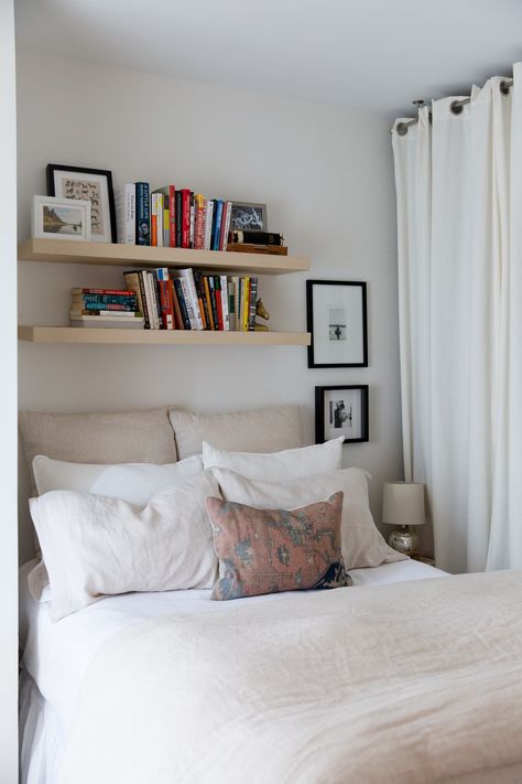 Small Space Storage Ideas from a Brooklyn Apartment | Apartment Therapy Floating Shelves In Small Bedroom, Small Bedroom With Floating Shelves, Floating Shelf Above Headboard, Above The Bed Floating Shelf, Floating Shelves For Books Bedroom, Small Bedroom Wall Shelves, Floating Shelf With Books, Small Bedroom Book Storage, Small Book Storage Ideas