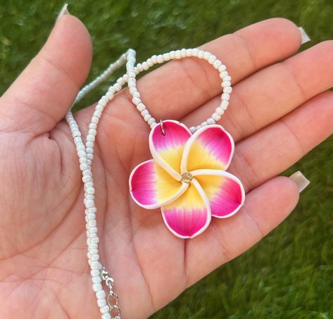 Here are some gorgeous necklaces newly available from Hawaii! The matching earrings are included as a set! These are beautifully made white beaded necklaces with a flower pendant that also has a diamond in the middle! They come in pink or purple! Makes for a beautiful gift for both adults,  kids, and anyone who wants to bring home a little aloha! 🌺 Plumeria Flower Necklace, Hibiscus Flower Necklace, Hawaiian Flower Necklace, Hibiscus Necklace, Hawaii Necklace, Pendant Necklace Diamond, Flower Necklaces, Hawaiian Plumeria, Hawaii Jewelry