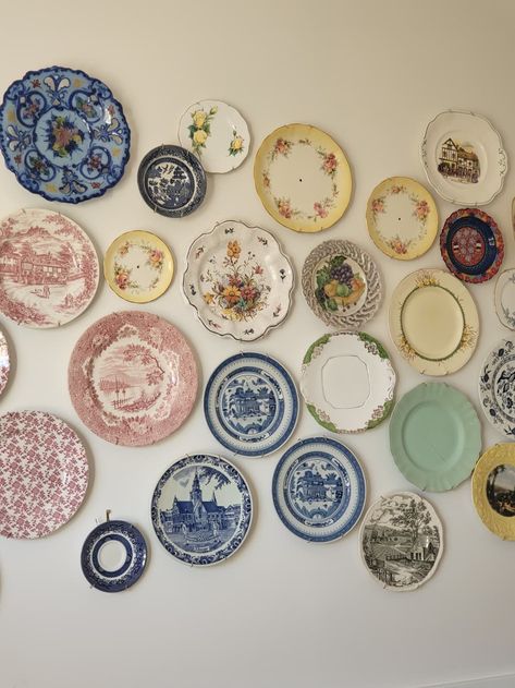 The vintage plates are all sourced from thrift stores.  Credit: Collette China Plate Gallery Wall, Wall Of Plates Decor, Decorative Plate Wall Display, Vintage Plate Wall Decor, Kitchen Plate Display, Plates On Wall In Bedroom, Cute Plates Set, Trinket Collection Aesthetic, Thrift Decor Ideas Living Rooms