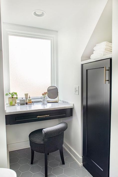 Black floating makeup vanity in a bathroom nook under a window featuring a floating marble countertop and a charcoal gray stool. Makeup Vanity Nook In Bathroom, Built In Makeup Table, Floating Vanity With Makeup Area, Window Vanity Bedroom, Makeup Vanity Under Window, Window Makeup Vanity, Makeup Vanity Nook, Floating Makeup Vanity Diy, Vanity Under Window