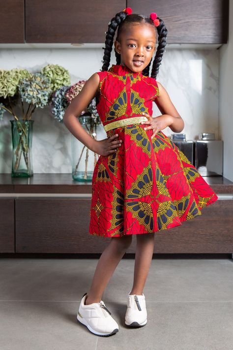 African Print Dress for Girls | Sleeveless Turtleneck Midi Red & Gold Party Dress for Girls - CORDELIA Our iconic Turtleneck style and our Sleeveless Turtleneck Midi Dress for Girls is exactly what you need when you want only the very best for your Girls. Featuring a tulle underskirt for extra flare and a vibrant Ankara pattern, this African Print Dress for Girls is perfect for stylish culture representation at every occasion, including weddings, photoshoots & birthday parties! There's never bee African Traditional Dresses For Kids Girl, Ankara Dress For Girl Child, Children African Dresses, Ankara Dress Styles For Children, Children's Ankara Dress Styles, Girls Traditional Dresses, Kids African Dresses, Chitenge Patterns, Kids Traditional Dress