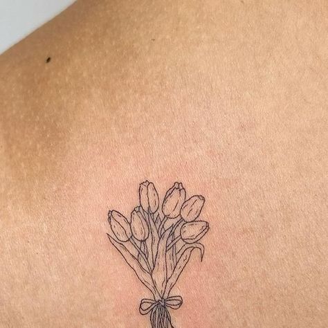 sam- nyc fineline tattoo artist on Instagram: "📍nyc- books are open! dm to book/inquire 🫶🏼dainty, cute, fineline, and pet portrait tattoos  a sweet little custom tulip bouquet for the lovely @kxssvo 💐💐  tysmmm💕  @helloinknyc 🤗  #daintytattoo #floraltattoos #tulip #nyctattoo #finelinetattoos" Simple Modern Tattoo, Dainty Linework Tattoo, Small Tulip Bouquet Tattoo, Spine Tattoos For Women Tulips, Vintage Tulip Tattoo, Bunch Of Tulips Tattoo, Vase Of Tulips Tattoo, Rose And Tulip Bouquet Tattoo, Mini Bouquet Tattoo