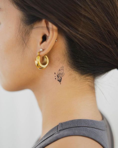 Explore the intricate world of small tattoos with our detailed guide. From choosing designs to finding the perfect spot, get ready to ink your story. Back Ear Tattoo, Tattoo Papillon, Tiny Butterfly Tattoo, A Small Tattoo, Butterfly Neck Tattoo, Small Neck Tattoos, Behind Ear Tattoos, Butterfly Tattoos For Women, Neck Tattoos Women