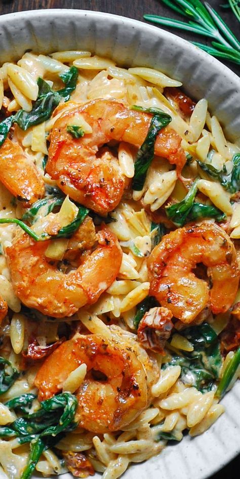 Creamy Tuscan Shrimp Pasta (Orzo) with Sun-Dried Tomatoes, Artichokes, and Spinach (30-Minute One-Pan Meal). Italian-inspired Autumn comfort food made with orzo pasta. This pasta dish is an easy weeknight meal to make during colder months of the year (Fall and Winter). #shrimppasta #pasta #comfortfood #creamyshrimppasta #creamypasta #orzo #orzorecipes #orzoideas #dinners #maindishes #maincourses #Italianfood #Italianrecipe One Pan Lemon Orzo Pasta With Shrimp, Seafood Veggie Pasta, Dishing Out Health Shrimp Orzo, Italian Shrimp And Rice Recipes, Shrimp Recipes Greek, Cooking With Orzo, One Sheet Pan Meals Shrimp, Easy Creamy Orzo Recipes, Shrimp Orzo Arugula