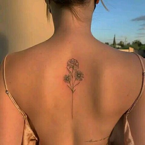 Back tattoo ideas for women Flower Bouquet Tattoo On Spine, Carnation Tattoo Spine, Flower Spine Tattoos Simple, Upper Back Flower Tattoo Women, Fine Like Spine Tattoo, Simple Line Spine Tattoo, Minimalist Back Tattoo Women Spine, Dainty Flower Back Tattoo, Medium Size Back Tattoos