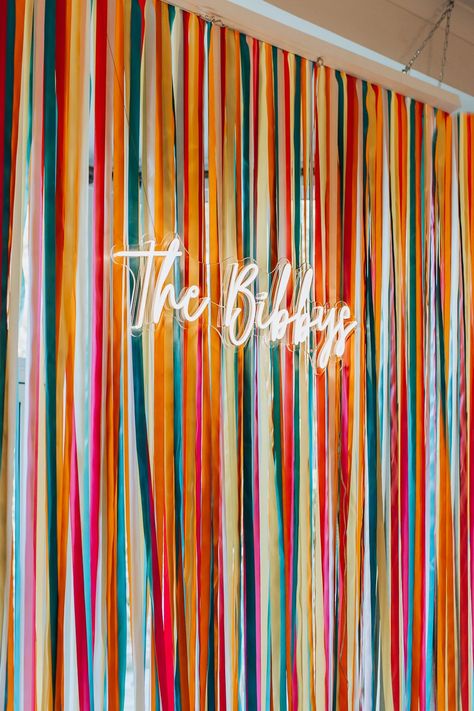 Wedding Backdrop For Photobooth, Colorful Party Backdrop, Neon Sign Backdrop Ideas, Diy Wedding Backdrop Cheap Indoor, Ribbon Wedding Backdrop, Ribbon Wall Backdrop, Wall Decor For Wedding Reception, Creative Wedding Backdrop, Colorful Photo Backdrop