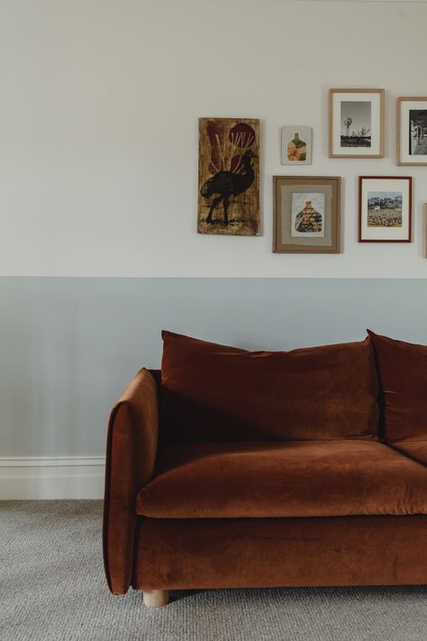 Rust velvet sofa against gallery wall Wall Half Painted, Sofa Gallery Wall, Rust Velvet Sofa, Green Sofa Interior, Brown Sofa Decor, Japanese Inspired Bathroom, Sandstone House, Japanese Bath House, Velvet Sofa Living Room