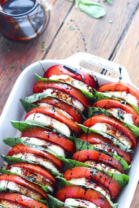 Tomato Mozzarella Salad with Balsamic Reduction. 17 Mediterranean Recipes That Are on the Keto Diet #purewow #dessert #recipe #dinner #lunch #ketogenic #food #mediterranean #mediterraneanrecipes #ketorecipes #ketomeals #caprese #mozzarella #easyappetizers Salad Caprese, Tomato Mozzarella Salad, Plats Healthy, Mozzarella Salad, Resep Salad, Resep Diet, Tomato Mozzarella, Balsamic Reduction, Makanan Diet