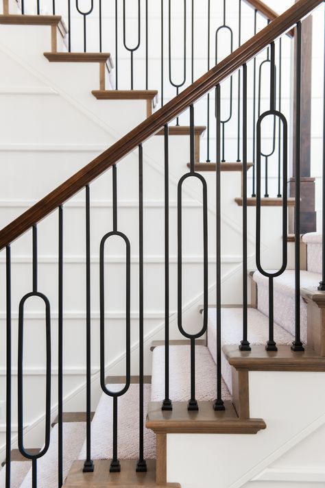 Oval iron baluster on staircase has the sleek clean lines of contemporary design with the cozy farmhouse aesthetic to create a uniquely fresh take on the country living inspired style. This look is characterized by natural textures and materials of wood mixed with satin black wrought iron to gives the warmth and simplicity. Decorating Staircase, Ms Railing, Baluster Design, Modern Farmhouse Staircase, سلالم حلزونية, Staircase Inspiration, Iron Staircase Railing, درابزين السلم, Stairs Modern