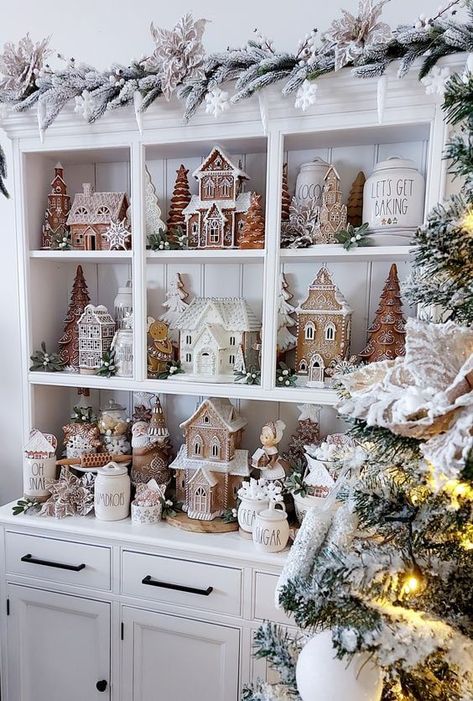 Get ready to step into a scrumptious holiday wonderland with my 30 Gingerbread Christmas decor ideas! From simple touches to grand statements, these ideas will fill your home with festive cheer and sweet, cozy vibes. Grab a hot cocoa, and start discovering your next holiday inspiration! Neutral Christmas Village Display, Village Houses Christmas, Christmas Rae Dunn Hutch, White Christmas Tree Gingerbread Theme, Neutral Christmas Village, Christmas Decorations Gingerbread Theme, Neutral Gingerbread Display, Vintage Gingerbread Decor, Rae Dunn Gingerbread