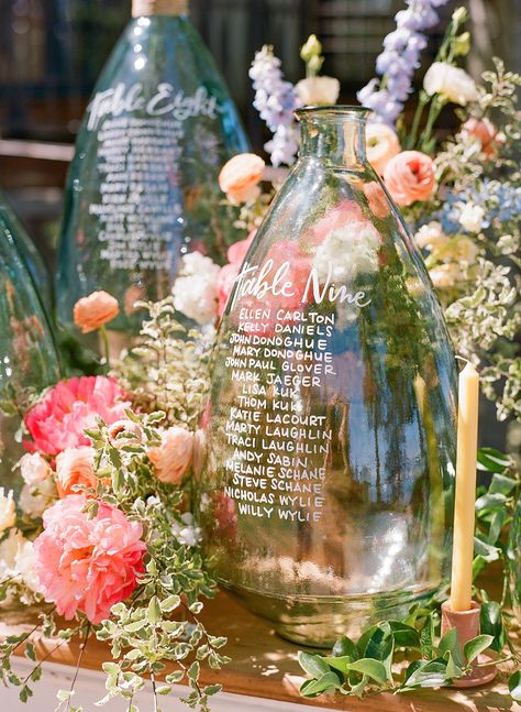 Whimsical Destination Wedding, Vase Table Seating Chart, Lake Wedding Alter Ideas, Unique Table Chart Wedding, Table Assignment Display, Unique Table Assignments Wedding, Destination Seating Chart, Wedding Guest Seating Chart Display, Wedding Table Assignment Ideas