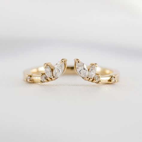 The organic design of our Claire marquise wedding ring perfectly complements round, oval, pear, or marquise engagement rings. A distinctive open center creates a contemporary feel, allowing for a seamless fit with your engagement ring. If you love a more dramatic look, the Claire wedding band is spectacular in pairs, flanking the engagement ring on top and bottom. Meticulously handcrafted for a perfect fit, the diamond-dotted Claire marquise wedding makes an original yet elegant choice. Metals: Marquise Engagement Rings, Asymmetrical Engagement Ring, Marquise Eternity Band, Double Wedding Bands, Open Wedding Band, Marquise Wedding Ring, Round Wedding Band, Future Engagement Rings, Oval Diamond Engagement