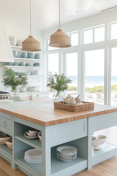 Transform your home with the latest kitchen design trends! This light and airy coastal kitchen showcases sleek open shelves, pastel blue cabinetry, and natural wood elements for a serene vibe. Perfect for a beach-inspired look. #KitchenDesign #HomeDecor #CoastalLiving Big Coastal Kitchen, New England Beach House Kitchen, Coastal Interiors Design Kitchen, Coastal Color Kitchen Cabinets, Coastal Modern Farmhouse Kitchen, Colorful Coastal Kitchen, Modern Coastal Kitchen Table, Light Blue And Wood Kitchen, Coastal Beach House Kitchen